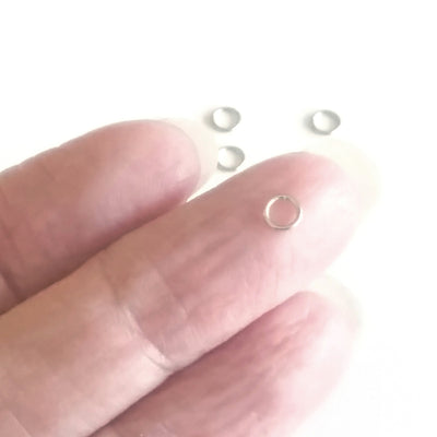 4mm jump rings shown on finger for comparison.