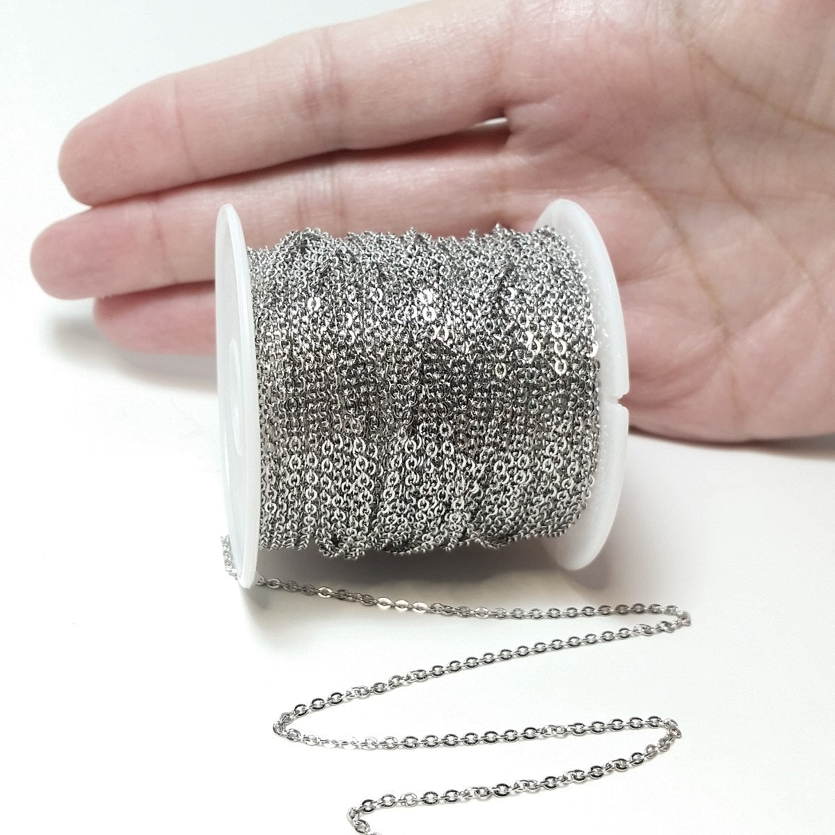 30 feet of chain on a small with hand behind spool for size comparison